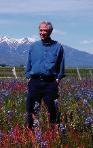 Herman I Neuman in field of Camas flowers near Idaho's Sawtooth Mountains.